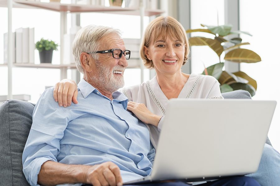 Older couple on couch with laptop